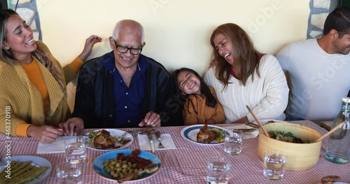 Happy latin family having fun eating together at home