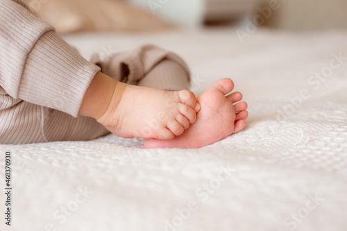 legs of a newborn baby in bedroom at home