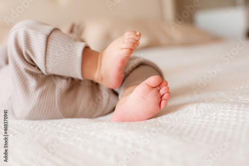 legs of a newborn baby in bedroom at home