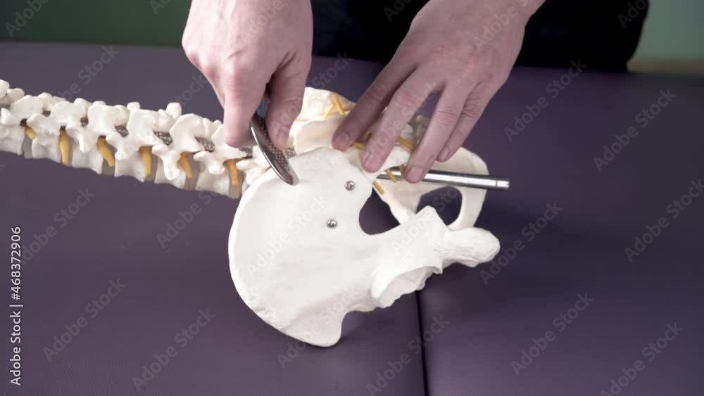 Physical therapist demonstrates how to apply IASTM tool to treat