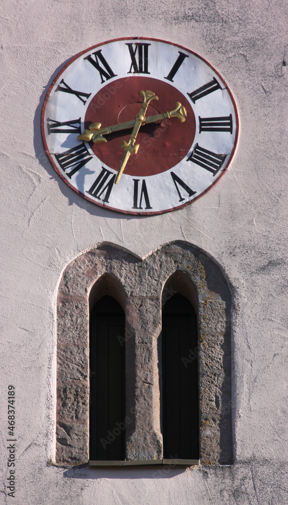 Gothic abat-son arches and clock at the medieval church tower of Rauenzell village, Franken region in Germany