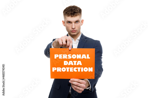 A businessman shows an inscription: PERSONAL DATA PROTECTION