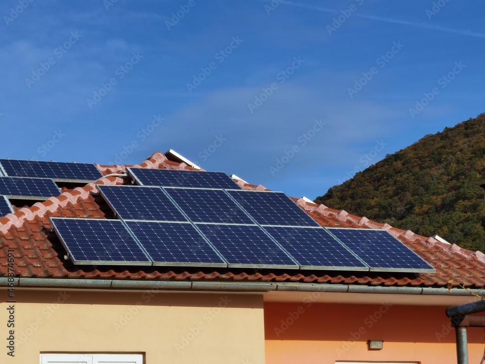 solar panels on house  roof, forest for background , electricity ecology renewable energy