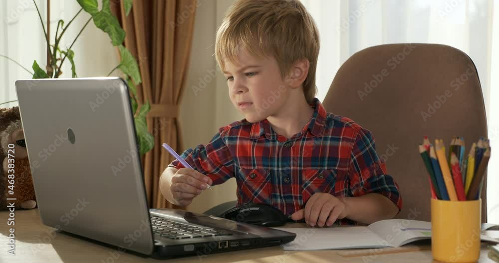 Child Study Online Lesson Video Conference Chat Using Laptop Computer. Kid Distance Learning at Home. Preschooler Boy Sits at Desk Table in Room Near Window 4K Child Study Online Lesson Video Conference Chat Using Laptop Computer. Kid Distance Learning at Home. Preschooler Boy Sits at Desk Table in Room Near Window 4K