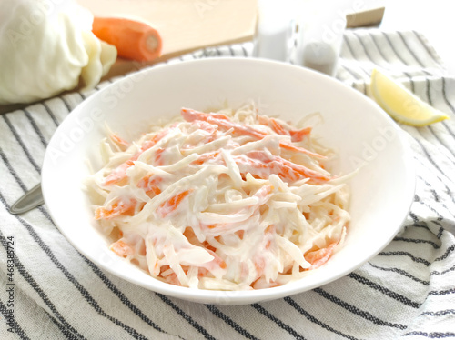 Obraz na płótnie Coleslaw salad with carrot and cabbage   in a white bowl.