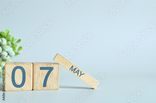 May 7, Calendar cover design with number cube with green fruit on blue background.	
