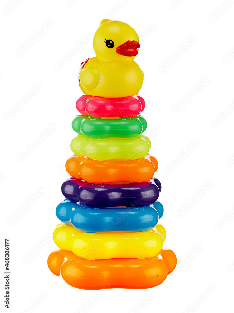 Pyramid toy with multicolored rings and a top in the form of a duck, isolated by a shadow on a white background. Pyramid toy with multicolored rings and a top in the form of a duck, isolated by a shadow on a white background.