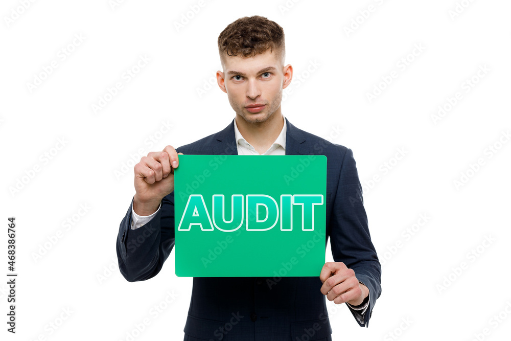 A businessman shows an inscription: AUDIT A businessman shows an inscription: AUDIT