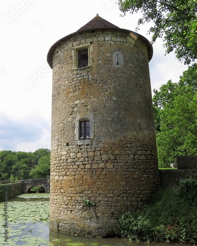 view of  Tower and moat around Benedictine abbey of Saint Junien in Nouaille Maupertuis France photo