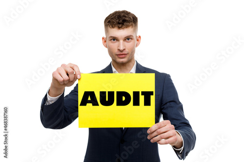 A businessman shows an inscription: AUDIT