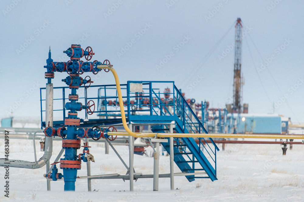 drilling rig on the background of wells and pipes