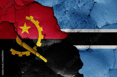 flags of Angola and Botswana painted on cracked wall photo