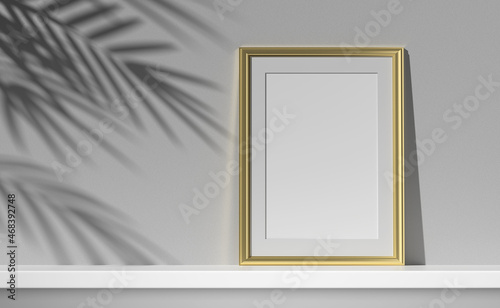 Obraz na płótnie Mockup gold poster frame on the shelf with palm shadow on the wall. 3D illustration. w salonie