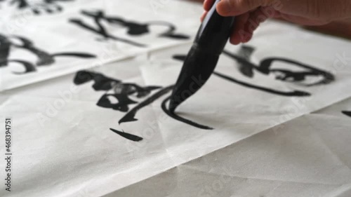An old calligrapher is writing calligraphy and writing calligraphy