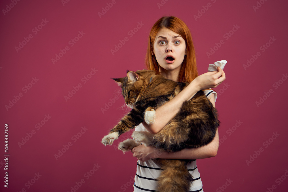 woman holding fluffy cat in her arms pet friendship pink background