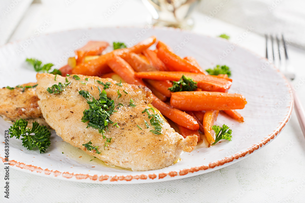 Fried chicken fillet garnished with caramelized carrots. Dinner. Fried chicken fillet garnished with caramelized carrots. Dinner.
