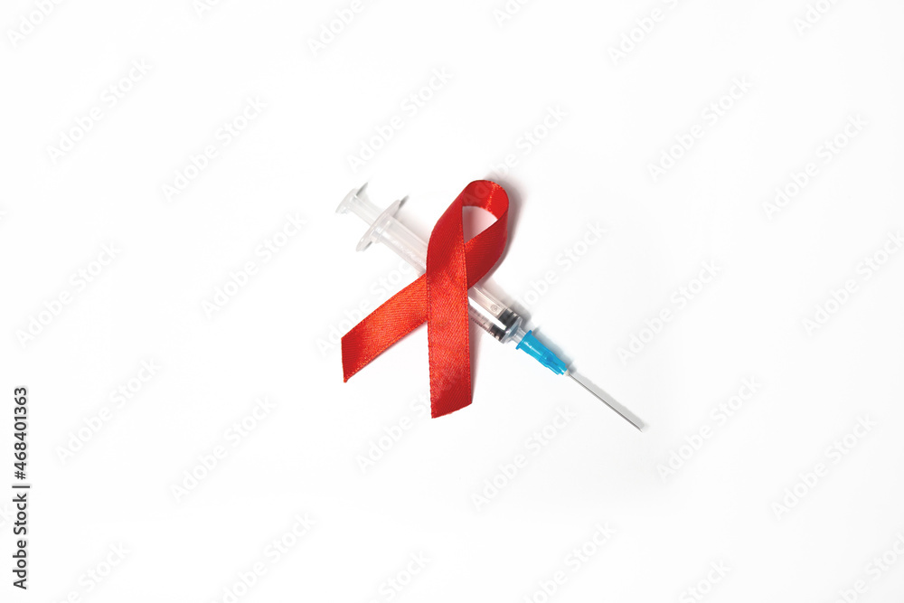 medical syringe with red tape symbol of AIDS on white background