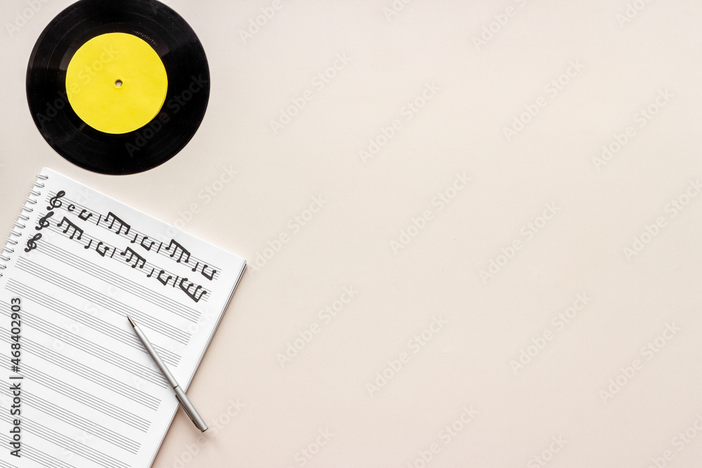 Sheets with music notes and vinyl record. Compose music concept Sheets with music notes and vinyl record. Compose music concept