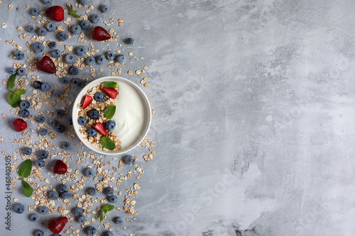 Yoghurt with fruit and granola. Heaithy breafast. Strawberries and blueberries are useful. photo