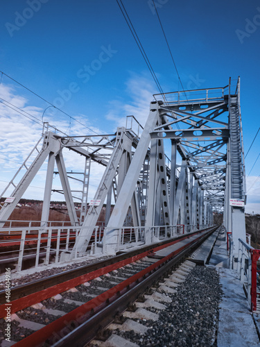 Railroad bridge of metal beams.