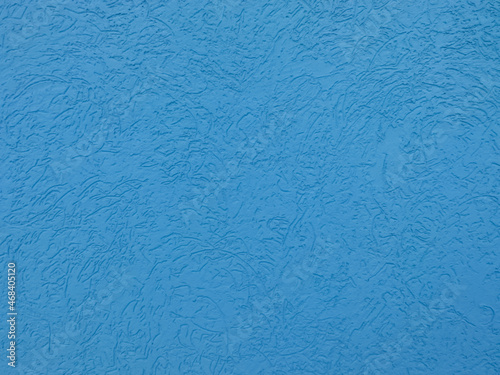 Blue plastered wall with bark beetle type surface.