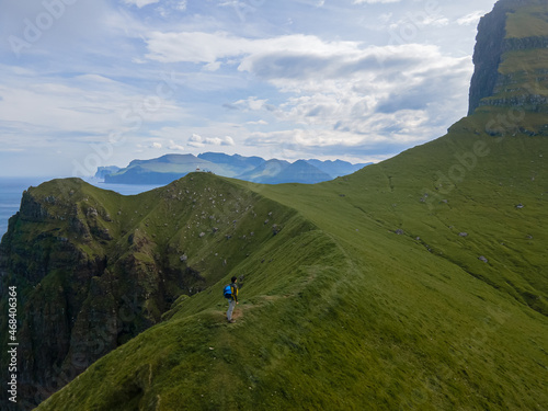 Beautiful aerial view of the Kallur Lighthouse in the Faroe Islands, and its massive cliffs, crags hikes and ocean views