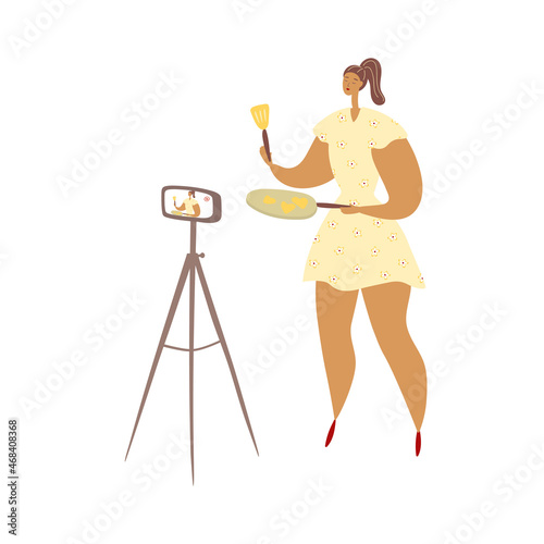 Woman is holding frying pan and kitchen spatula in her hands. Cook kitchener is standing in front of camera and filming video. Flat cartoon character