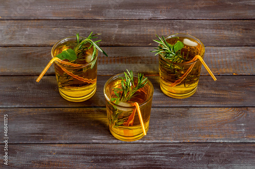 Herbal cold tea beverage with rosemary in glasses