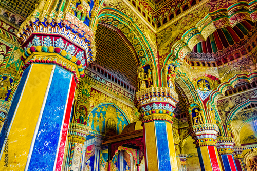 Thanjavur, Tamil Nadu, India - The high arches artworks and colorfully painted wall murals and ceilings of the ancient 17th-century durbar hall Maratha Palace in the town of Thanjavur photo