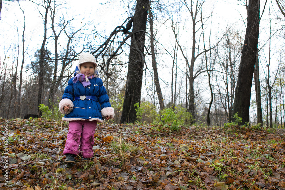 child playing in autumn park child playing in autumn park