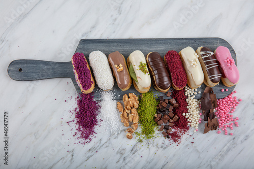 Prepared for special occasions, delicious and beautiful chocolate small cake ekler pastry. Ekler Pasta. Chocolate Donut with pistachio powder. photo