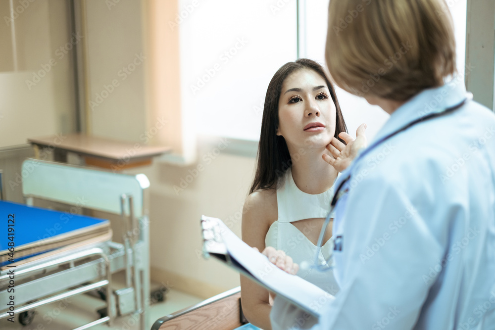Obraz premium Asian female in the aesthetic clinic with hand of doctor are examining her face. Beautiful woman before plastic surgery operation cosmetology. Beauty surgery. Aesthetic medical concept.