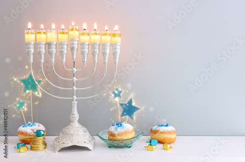 Religion image of jewish holiday Hanukkah background with menorah (traditional candelabra), doughnut and candles