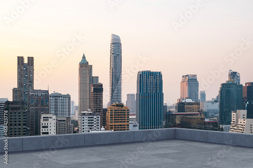 Panoramic Bangkok skyline view, concrete observatory deck on rooftop, sunset. Luxury Asian corporate and residential lifestyle. Financial city downtown, real estate. Product display mockup empty roof © VideoFlow