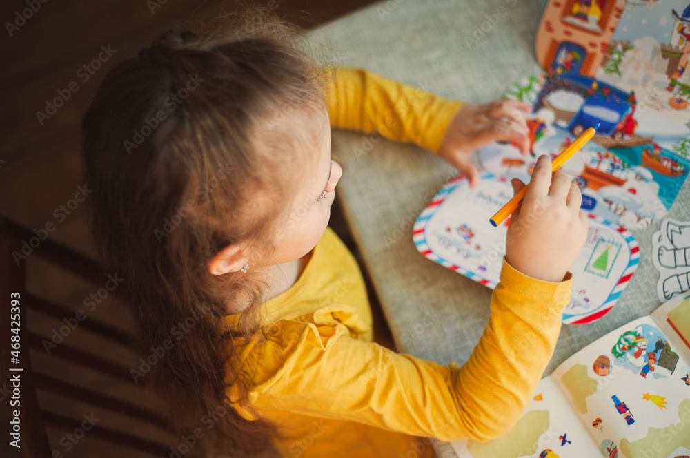 Cute little girl writes a letter to Santa Claus. Christmas concept Cute little girl writes a letter to Santa Claus. Christmas concept