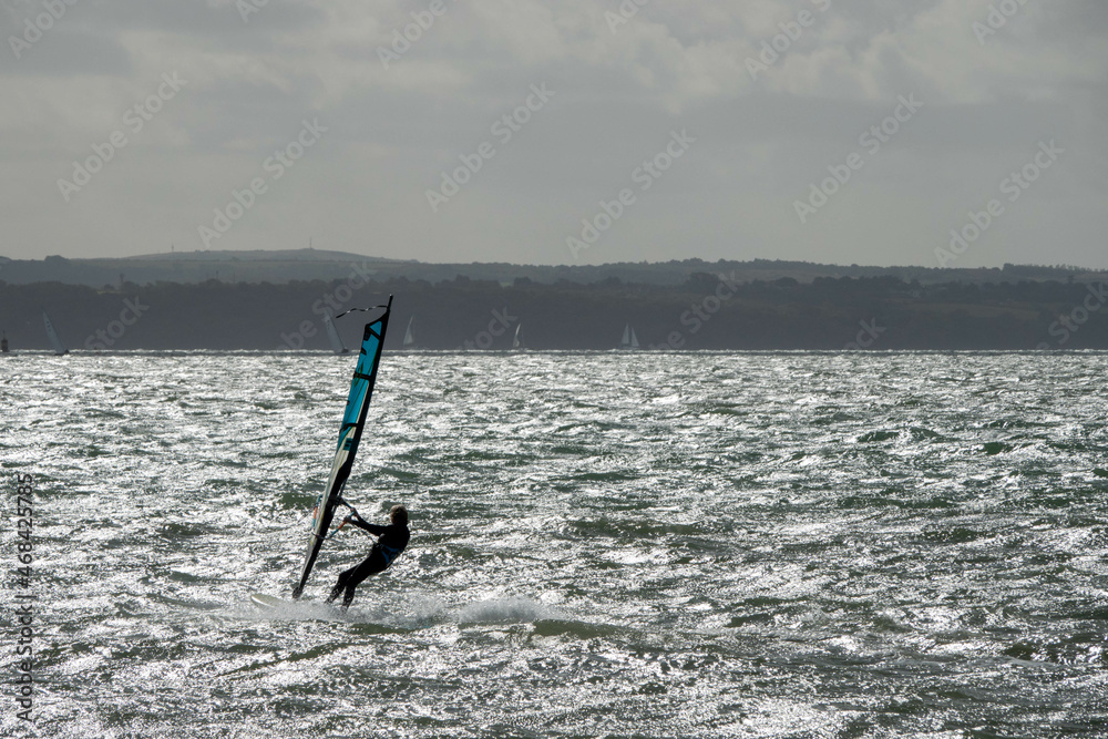 Naklejka premium Windsurfer on The Solent with The Isle of Wight in the background
