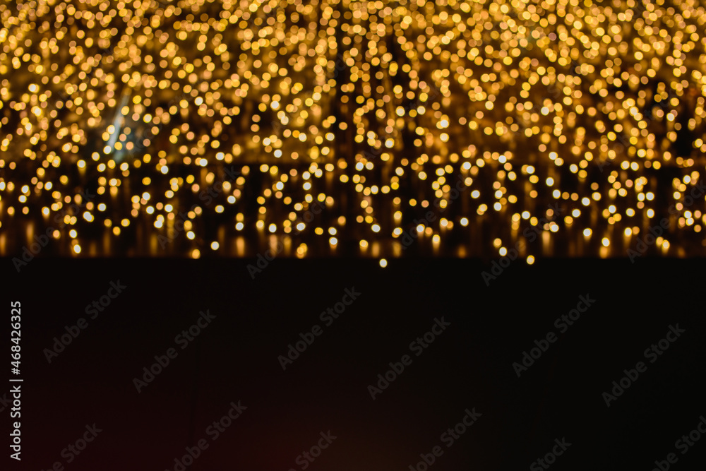 Naklejka premium Christmas lights. bokeh effect on black background. particles lights.