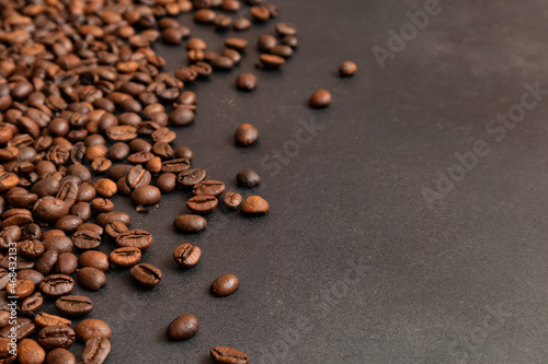 Fresh roasted coffee beans background. Selective focus. Copy space