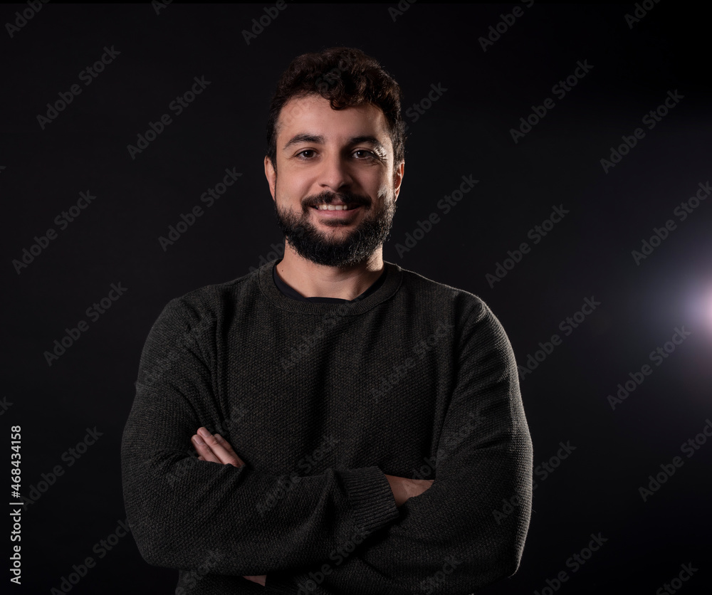 Bearded man in studio shot smiling looking at camera