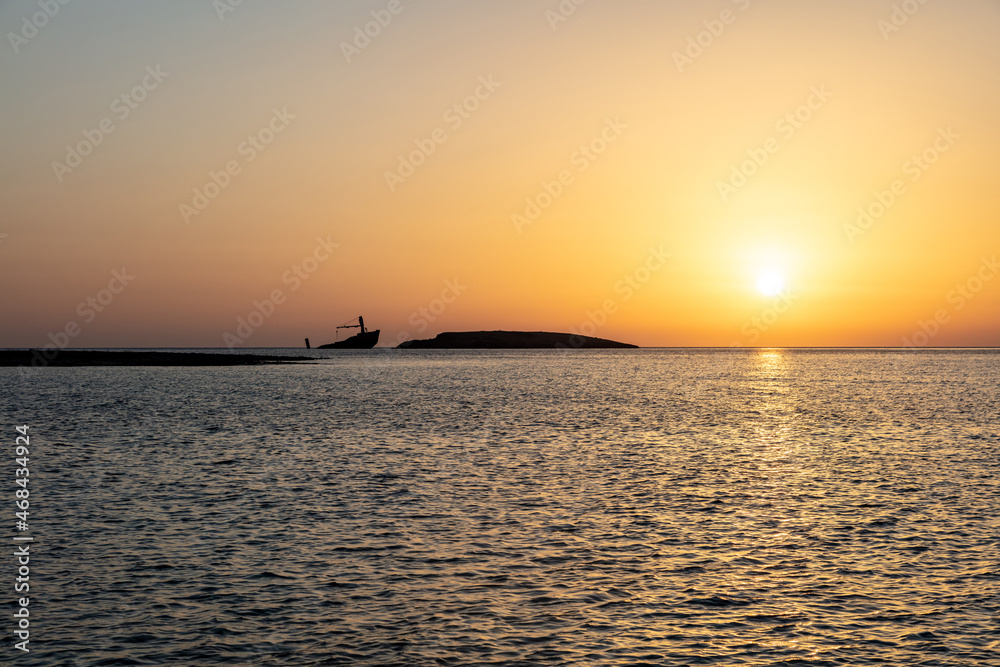Sunset over shipwreck of Nordland at seaside of village Diakofti Kythira island Greece.