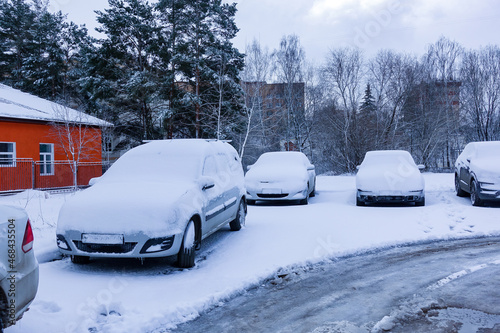 winter. The cars are covered with snow. Russia
