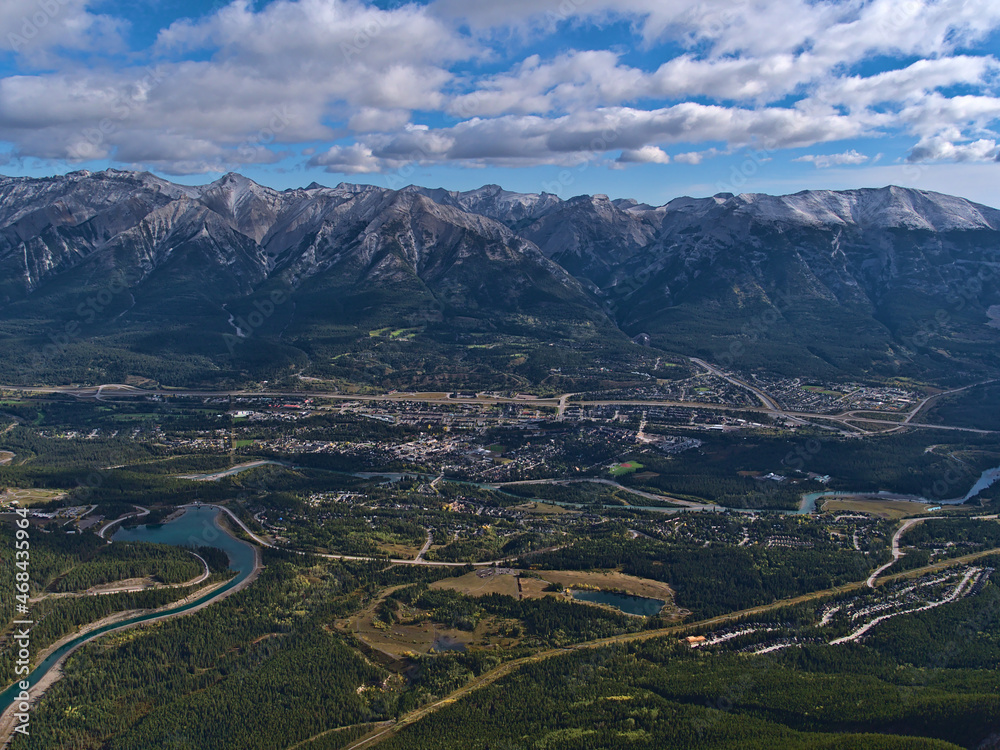 Beautiful aerial panoramic view of Bow Valley with town Canmore, Alberta, Canada in the Rocky Mountains with Rundle Forebay reservoir and forests.