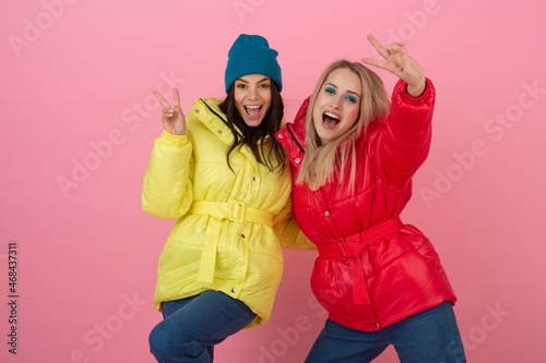 pretty women friends in colorful down jacket