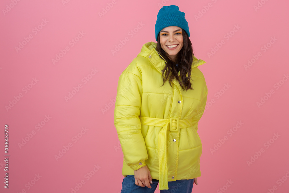 attractive active woman posing on pink background in colorful winter down jacket of bright ryellow color, smiling fun, warm coat fashion trend, crazy shocked surprised face expression attractive active woman posing on pink background in colorful winter down jacket of bright ryellow color, smiling fun, warm coat fashion trend, crazy shocked surprised face expression