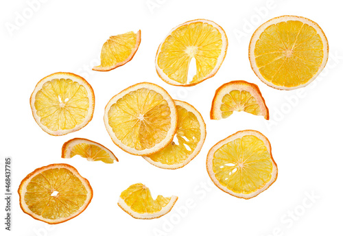 Dried orange slices falling close-up on a white background, cut. Isolated fruit chips