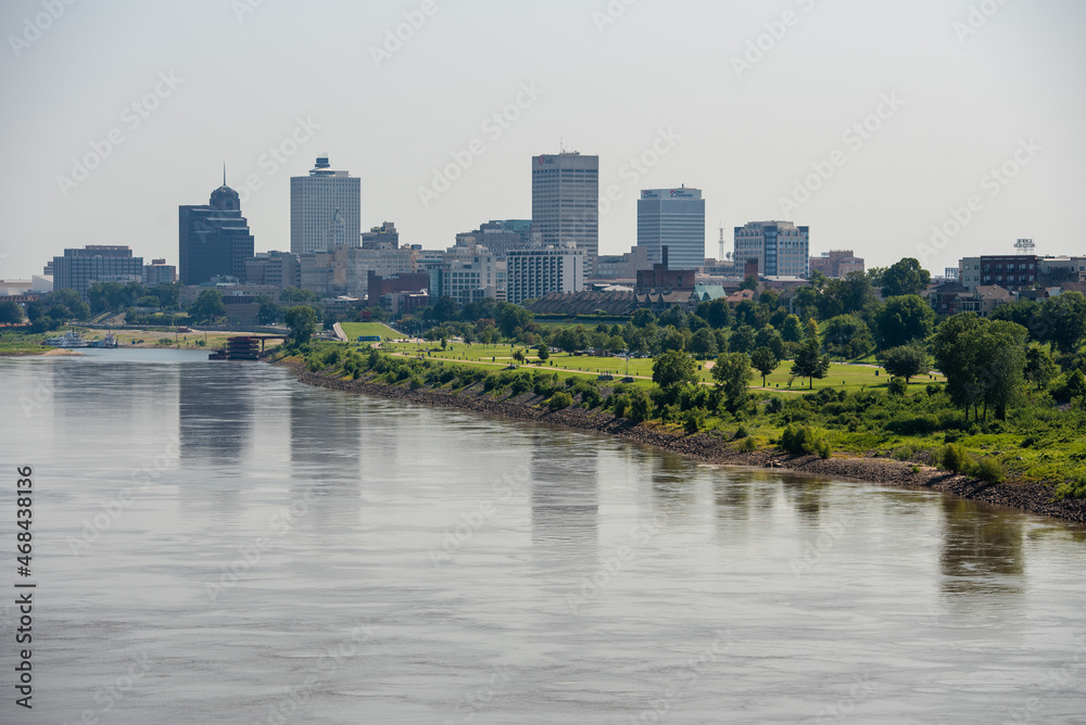 Memphis, TN cityscape reflecting on the water. View of green space