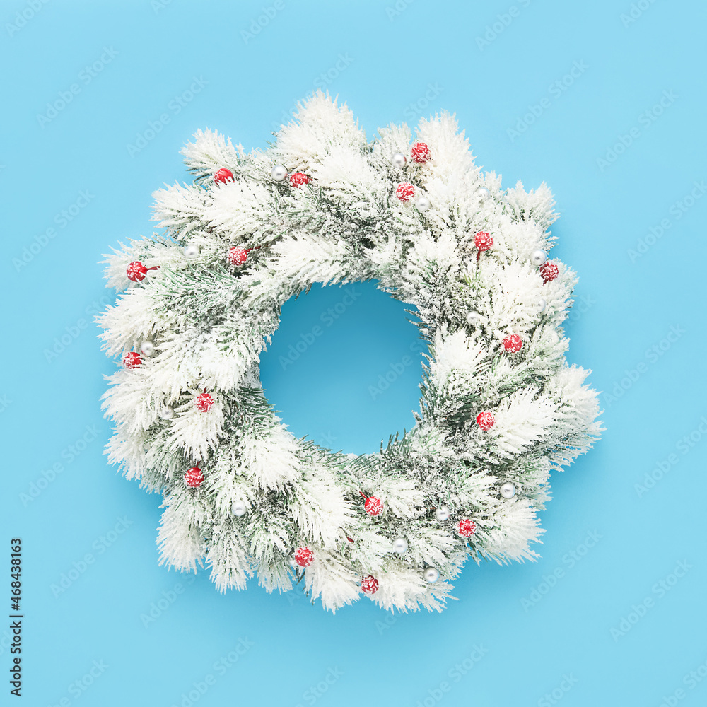 White christmas wreath with decoration on a light blue background. Flat lay White christmas wreath with decoration on a light blue background. Flat lay