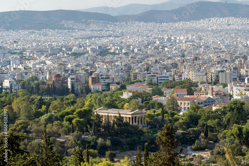 Athens, Greece. Panoramic view of the ancient greek Temple of Hephaestus located at the Ancient Agora of Athens archaeological site in Thissio district as seen from the Acropolis. Sunny day, aerial