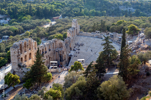 Panoramic view to the Odeon of Herodes Atticus (or Herodion) greek ancient theater as seen from the archaeological site of Acropolis. Sunny day, people