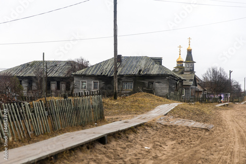 Kuzomen, Terskiy district, Murmansk region, Russia - November 2021. A village covered with sand after trees were cut down. Wooden sidewalks. photo
